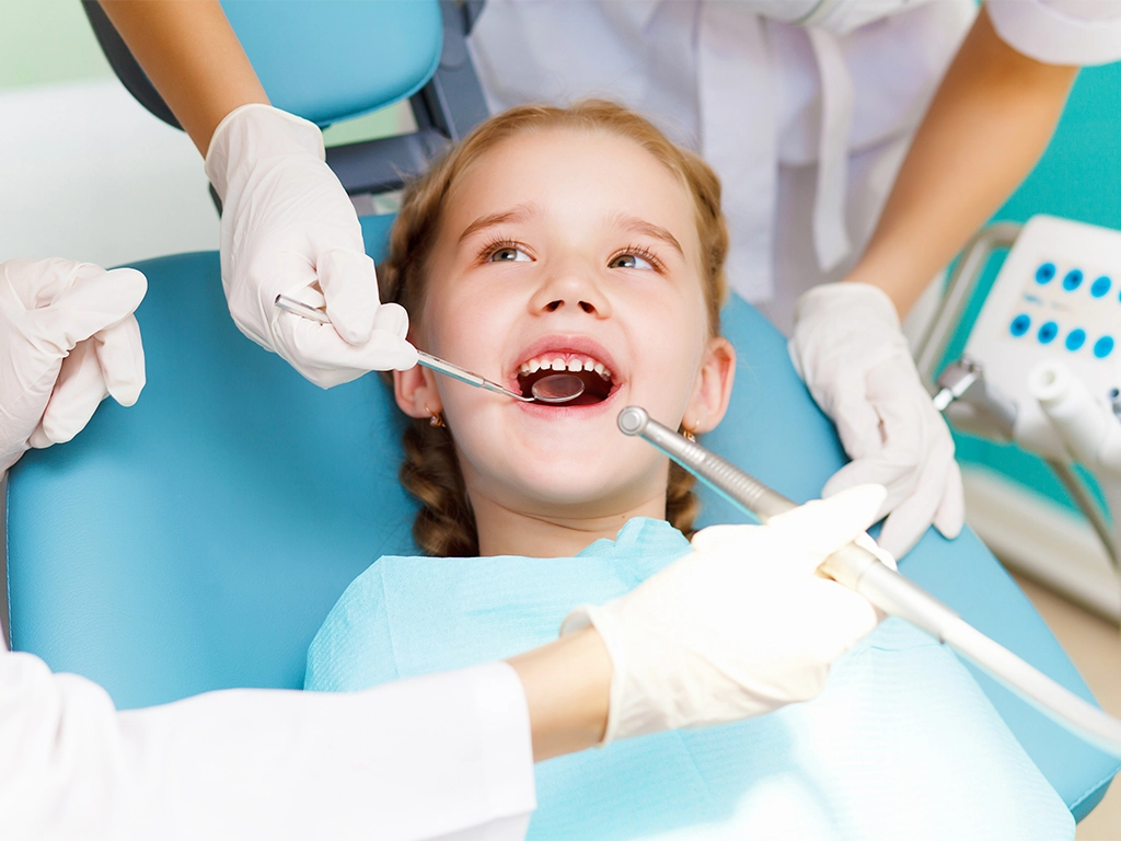 young girl happily visiting the dentist for a checkup